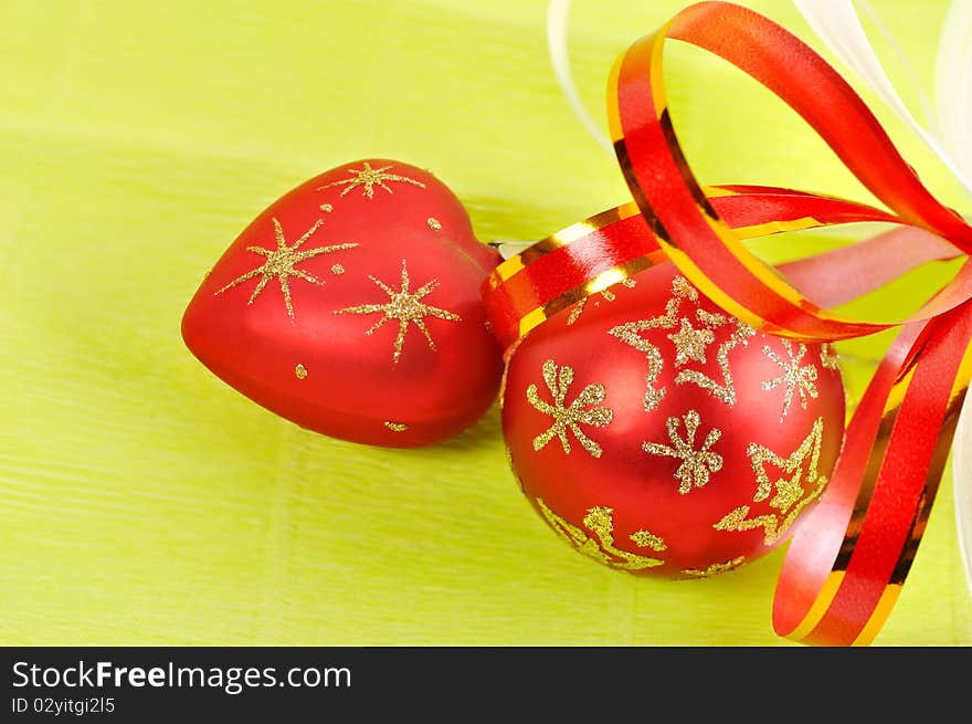 The two Christmas balls on a green background