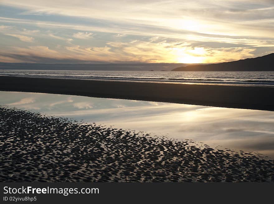 The sun sets over Kapiti Island, Peka Peka, New Zealand. The sun sets over Kapiti Island, Peka Peka, New Zealand