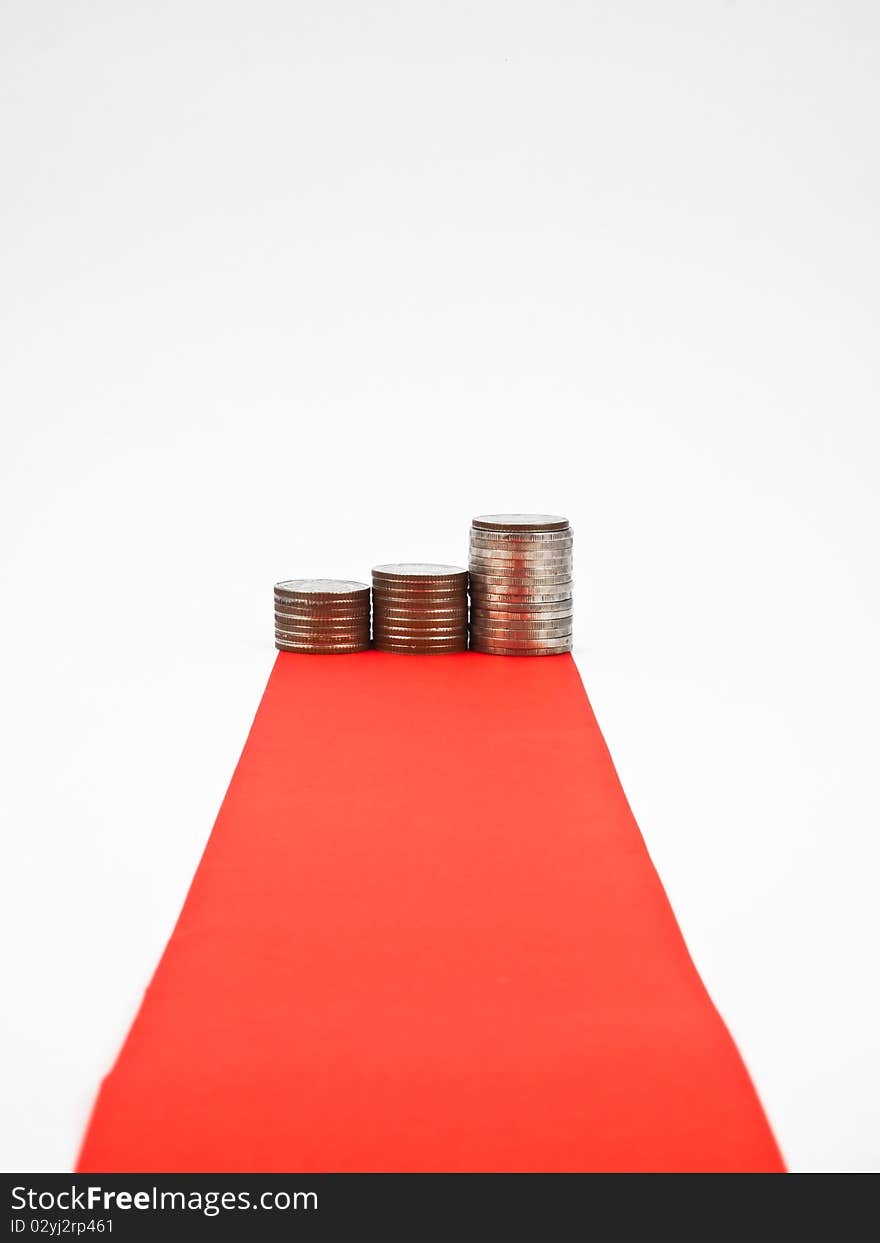 Red carpet and column of coin isolated on white background. Red carpet and column of coin isolated on white background