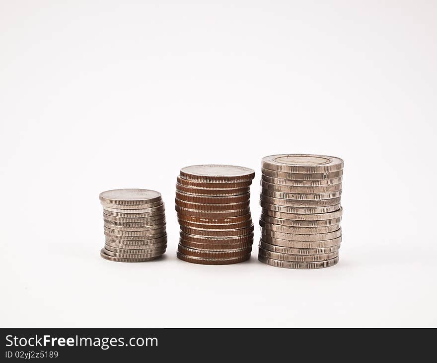 Columns of coins isolated on white background