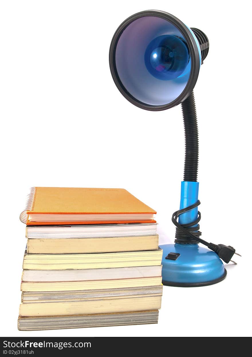 Desk lamp and book heap isolated on white background. Desk lamp and book heap isolated on white background