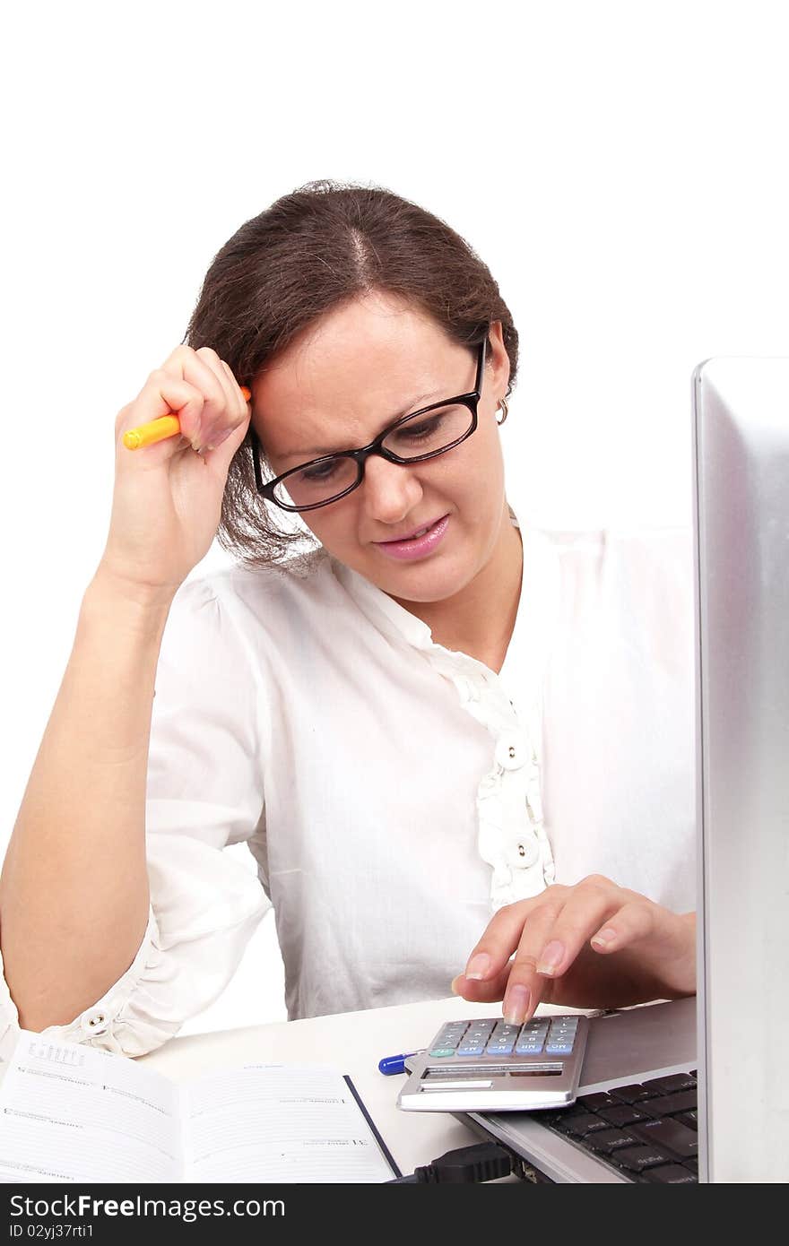 Businesswoman holding pencil in hand, sitting in office