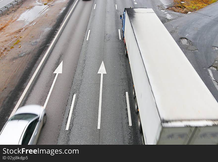 The image of automobiles drive under a highway