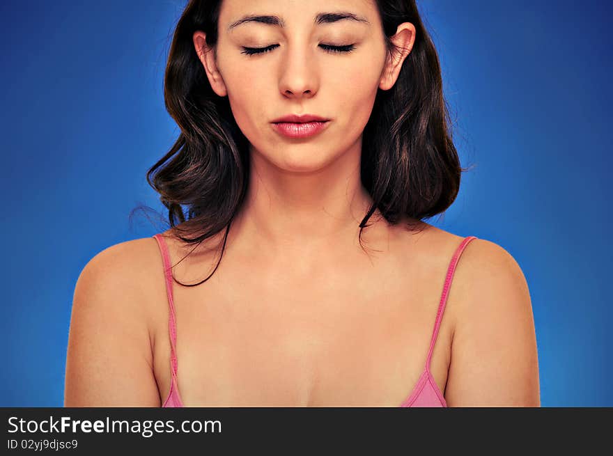 Beautiful woman portrait isolated over blue background