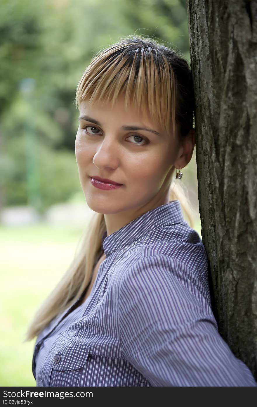 Portrait of an attractive young female in a park - Outdoor