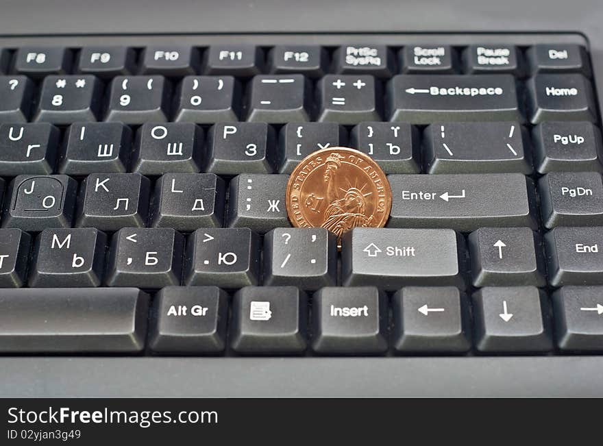 One dollar on a black computer keyboard. Studio shot. One dollar on a black computer keyboard. Studio shot