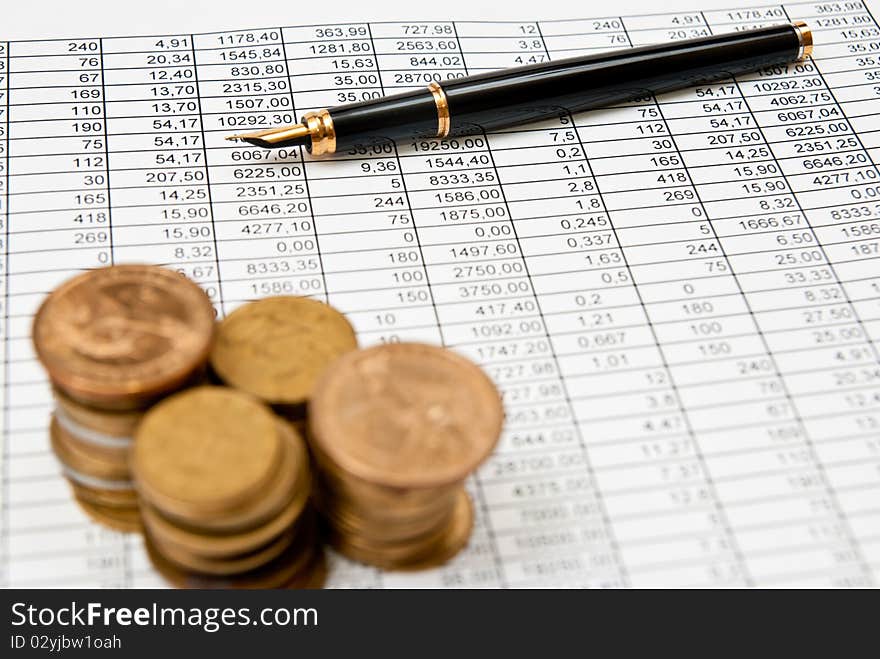 Financial document with numbers with coins stacks. Financial document with numbers with coins stacks