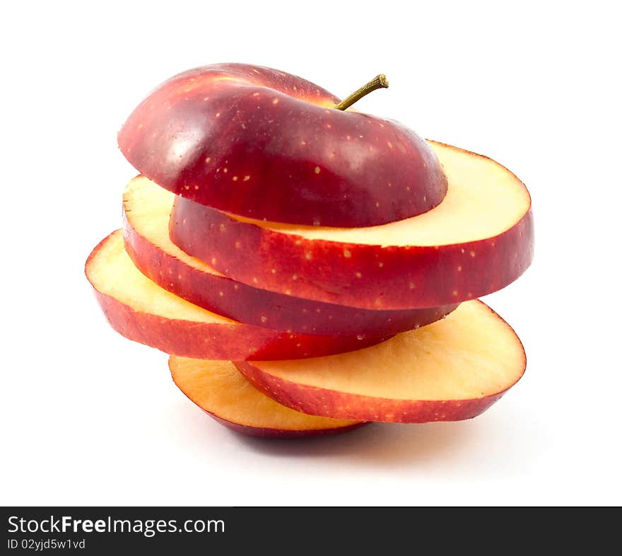 Chopped red apple slices on a white background