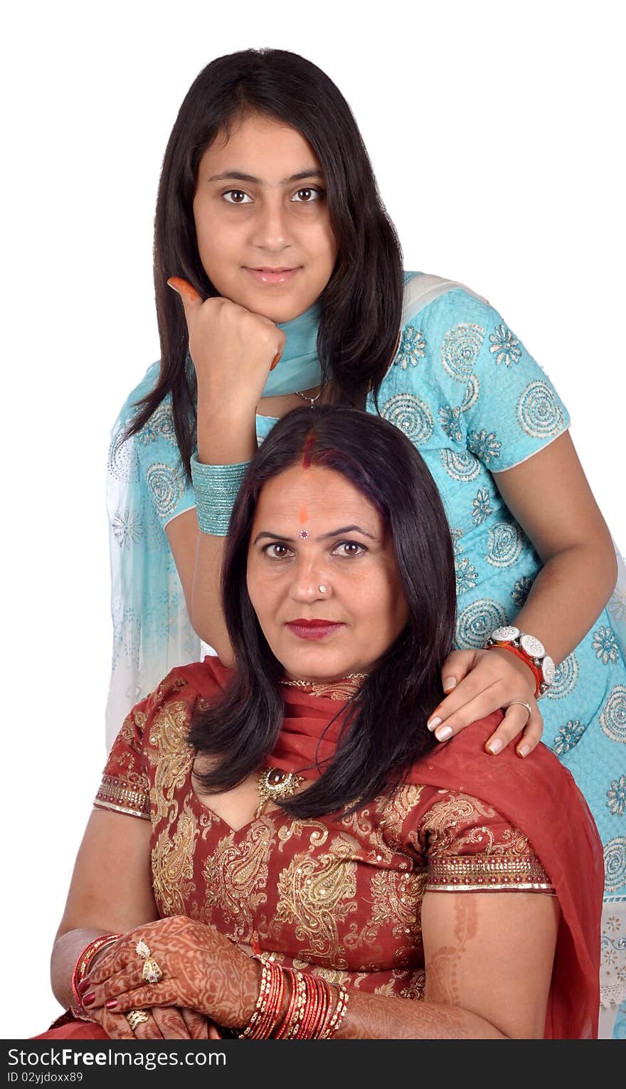 A young Indian girl making a beautiful portrait with her daughter isolated on white. A young Indian girl making a beautiful portrait with her daughter isolated on white.
