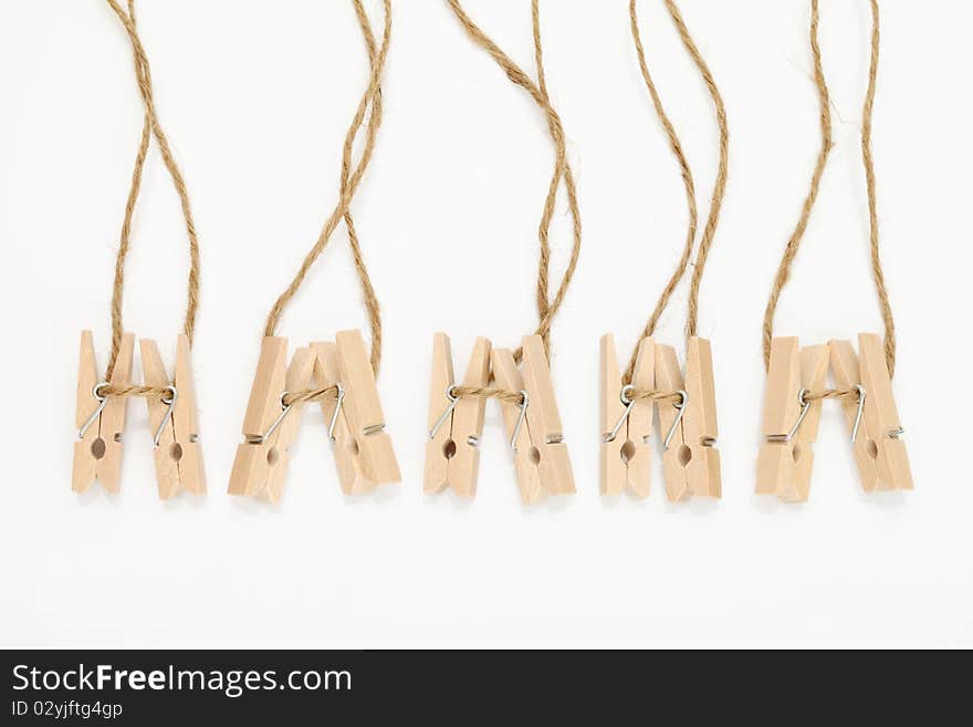 Wooden clothespins isolated on white background