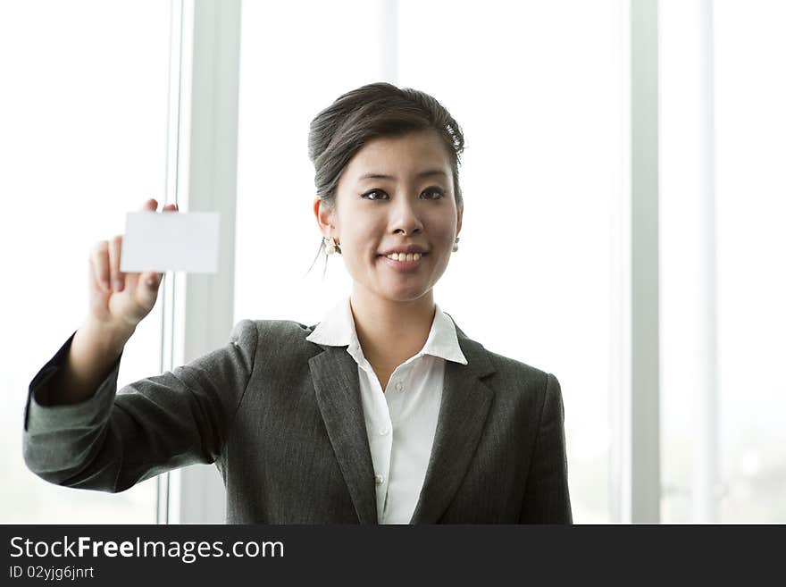 Chinese BUsinesswoman holding a blank businesscard