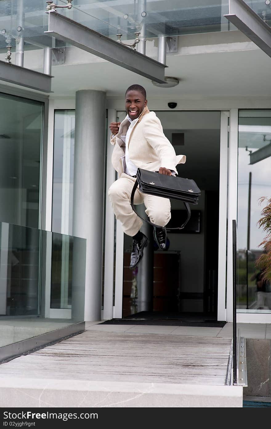 Businessman jumping of happiness outside his office