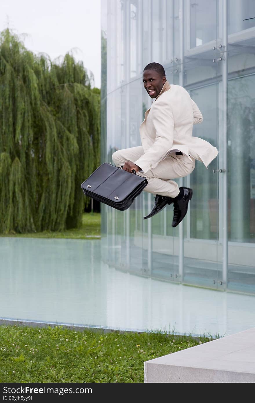 Businessman jumping of happiness outside his office