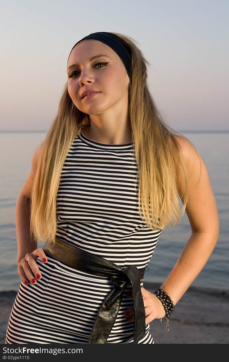 Beautiful young girl in black headband and dress. Beautiful young girl in black headband and dress