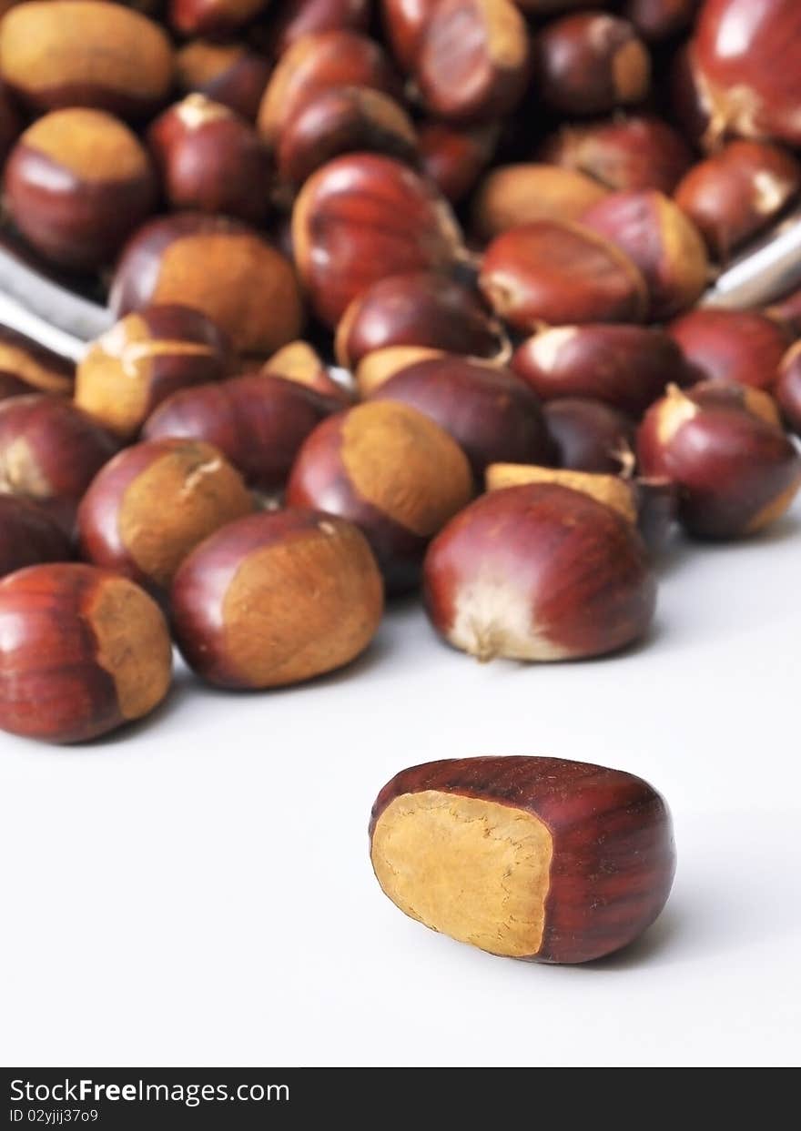 Quantity of chestnuts and overturned one isolated in the foreground. Quantity of chestnuts and overturned one isolated in the foreground