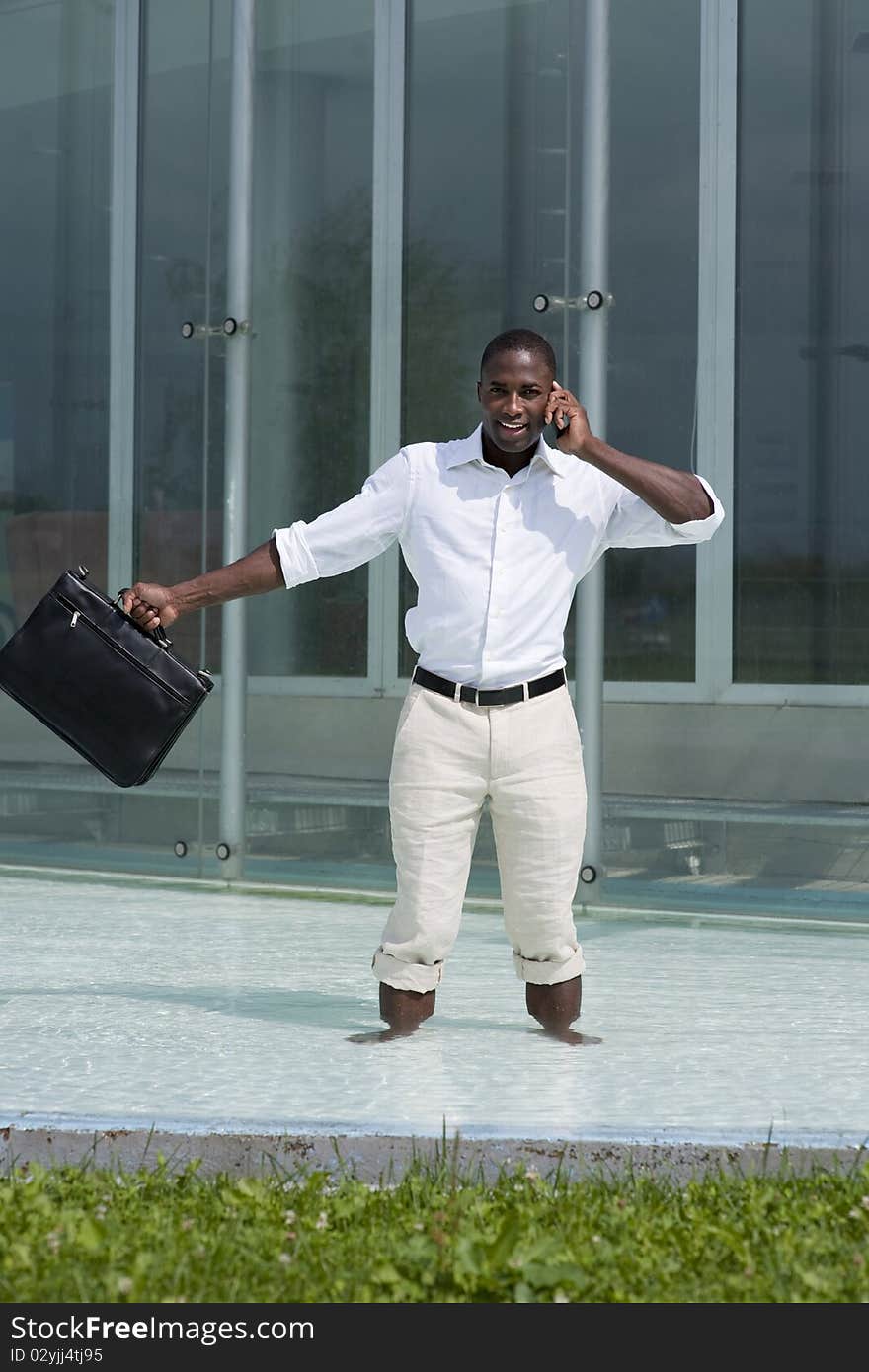 Businessman inside a pool speaking on the phone