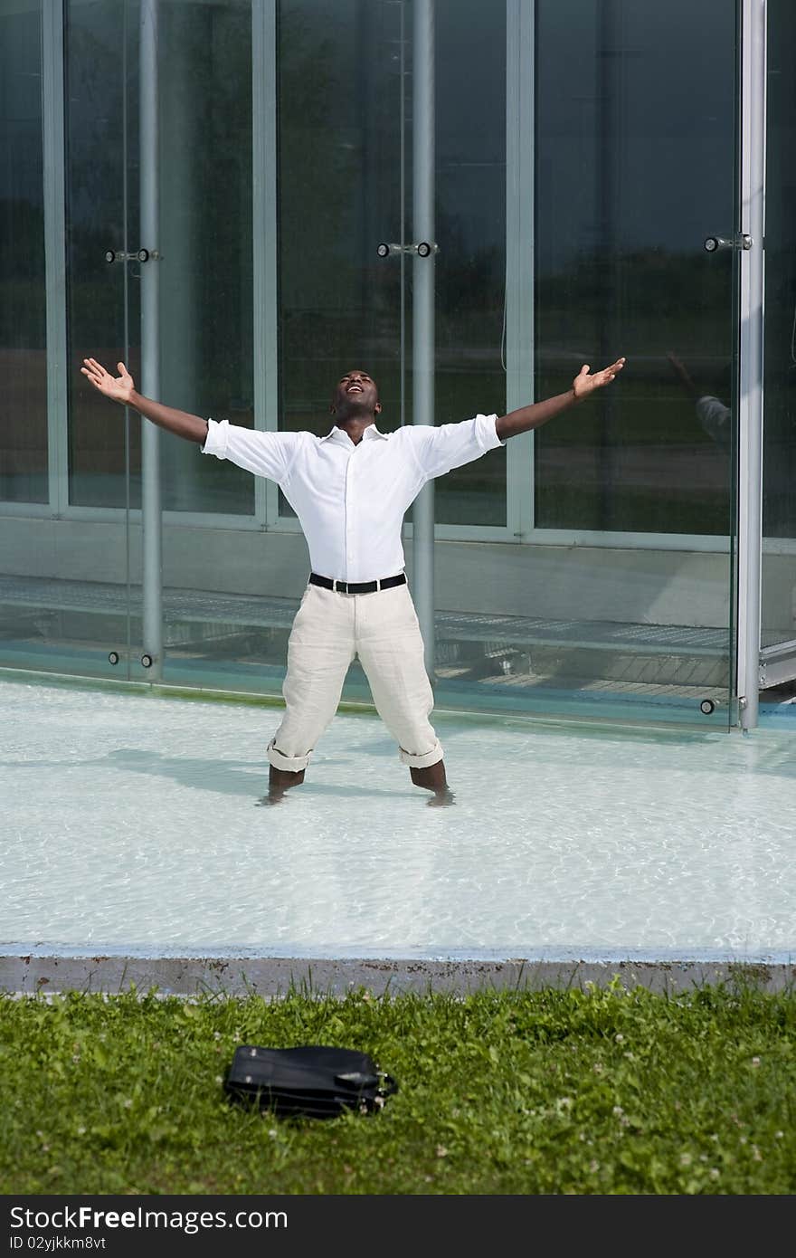 Businessman in the pool outside his office;  he could be excited beacuse he has just resigned. Businessman in the pool outside his office;  he could be excited beacuse he has just resigned