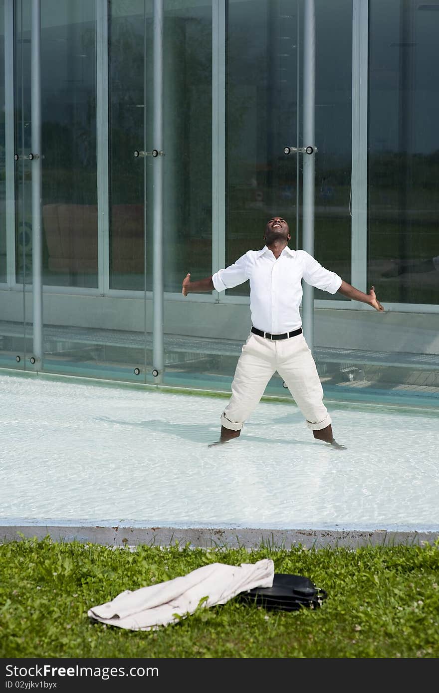 Businessman in the pool outside his office;  he could be excited beacuse he has just resigned. Businessman in the pool outside his office;  he could be excited beacuse he has just resigned