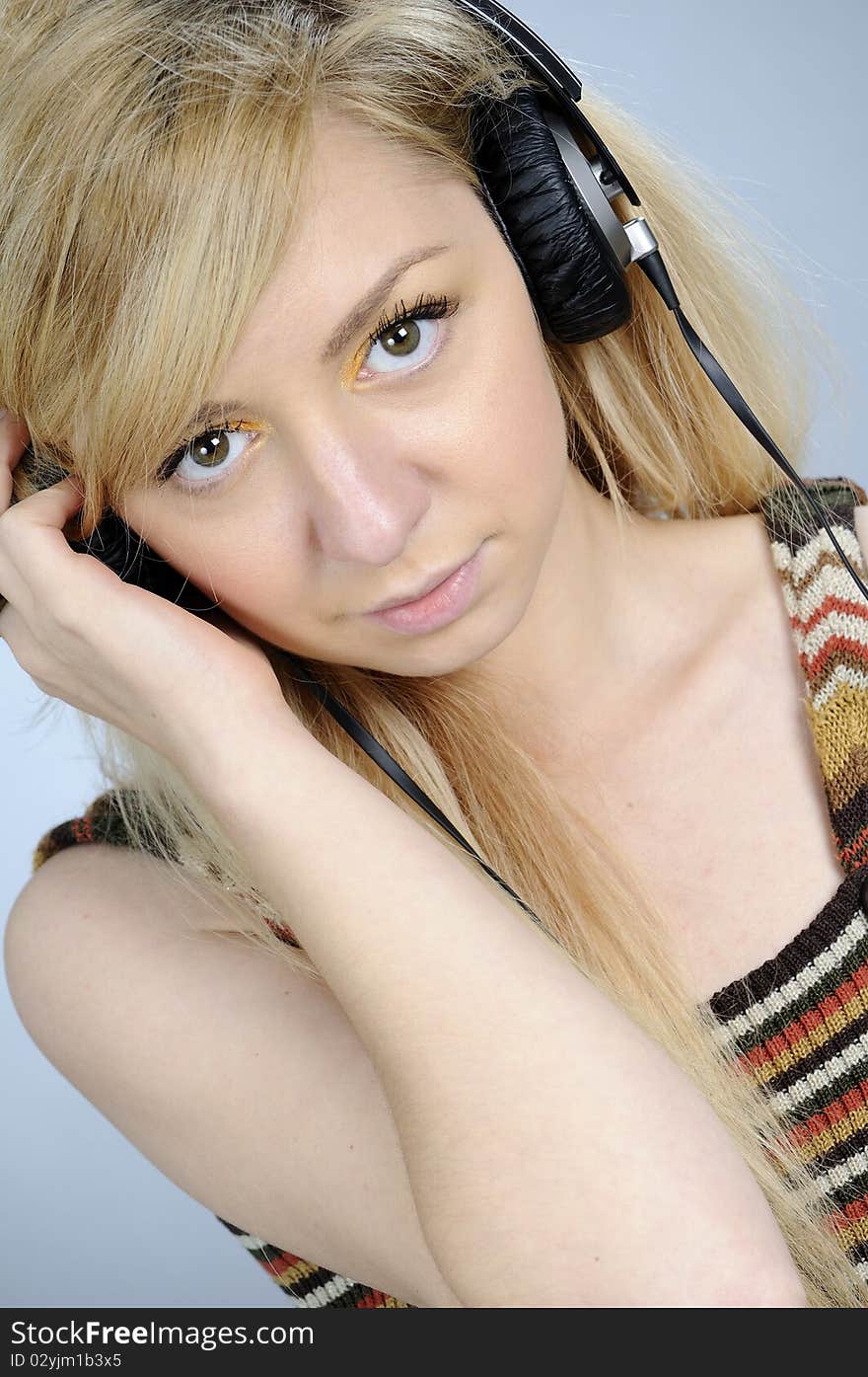 Young woman listening music on headphones. Young woman listening music on headphones