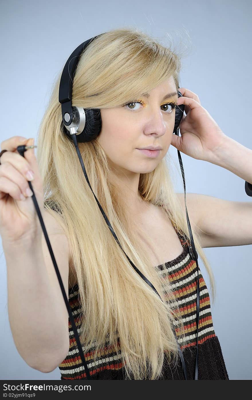 Young woman studying with audio equipments help. Young woman studying with audio equipments help