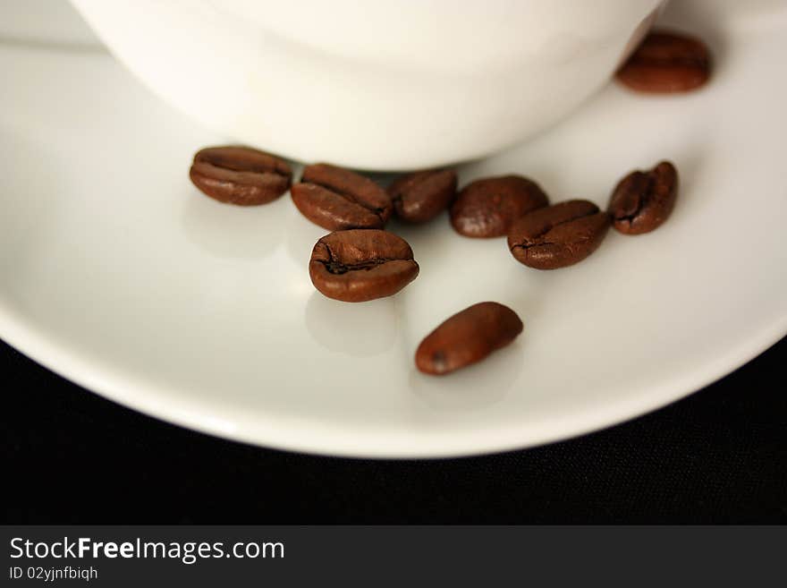 Coffee cup on black background and coffee beans. Coffee cup on black background and coffee beans