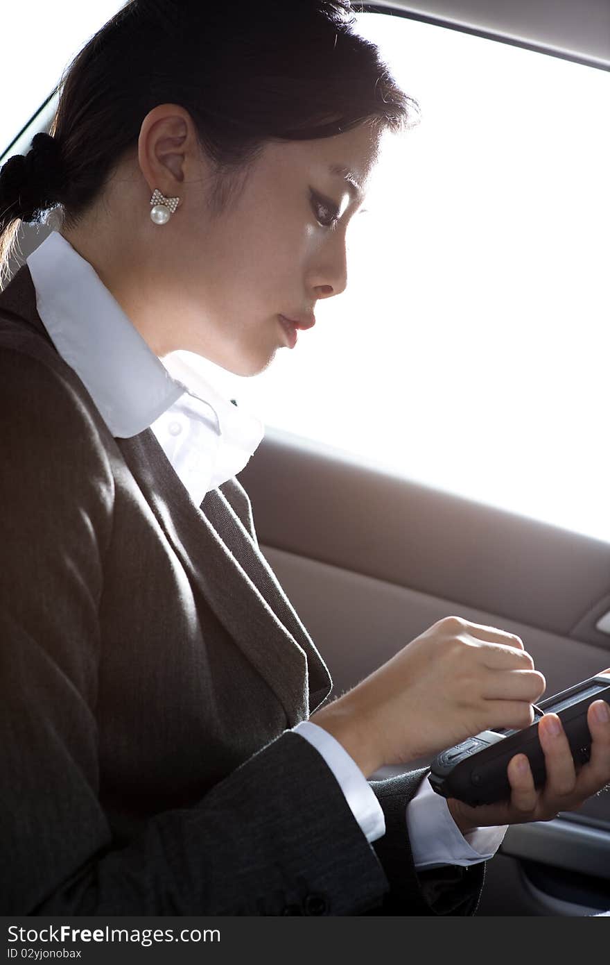 Young chinese business woman inside a car. Young chinese business woman inside a car