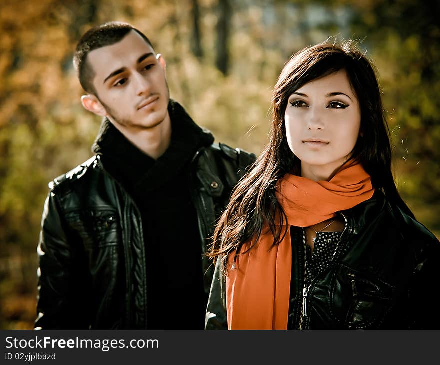 Young man is looking at beauty girl in fall outdoor. Young man is looking at beauty girl in fall outdoor