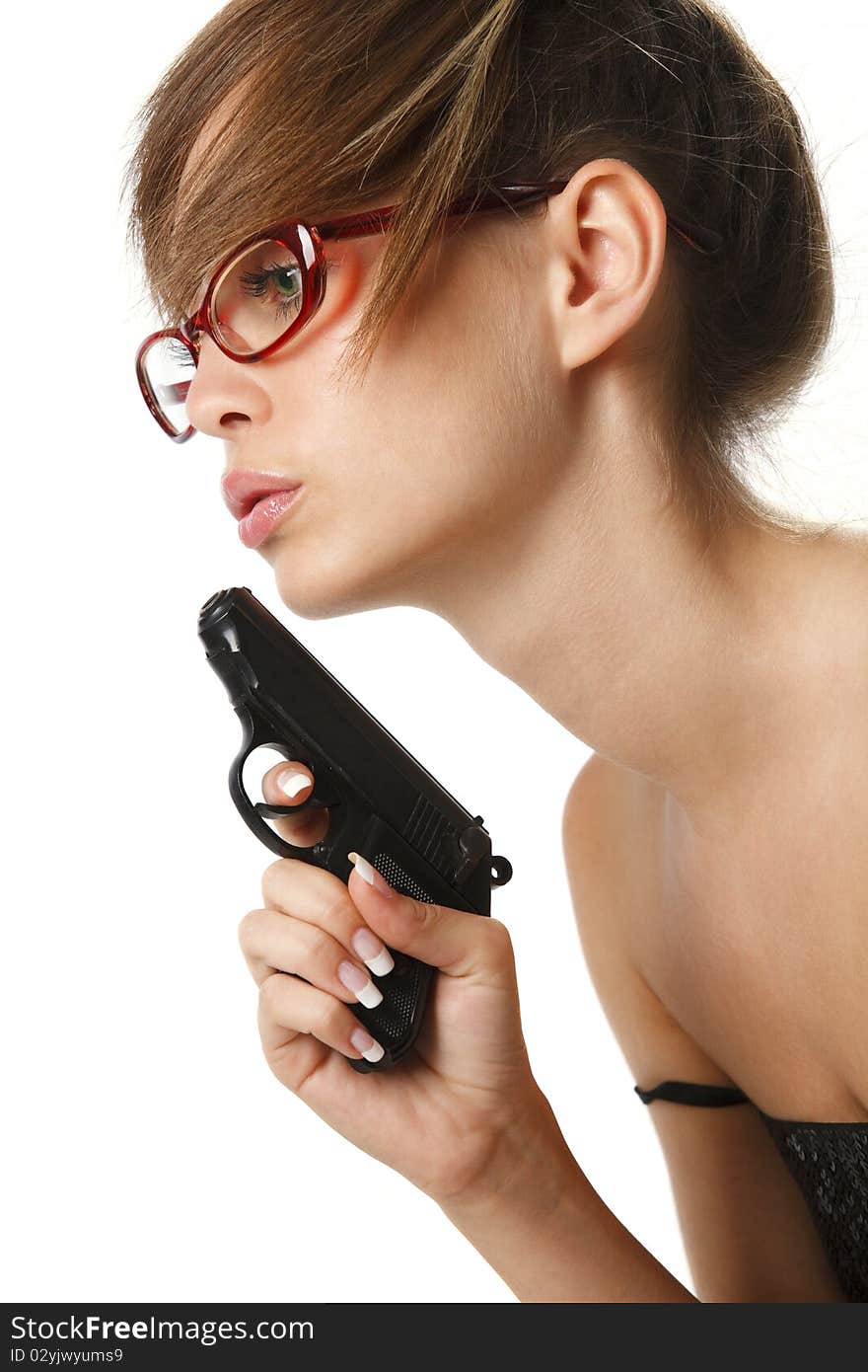 Attractive young woman in red glasses with handgun over white. Attractive young woman in red glasses with handgun over white