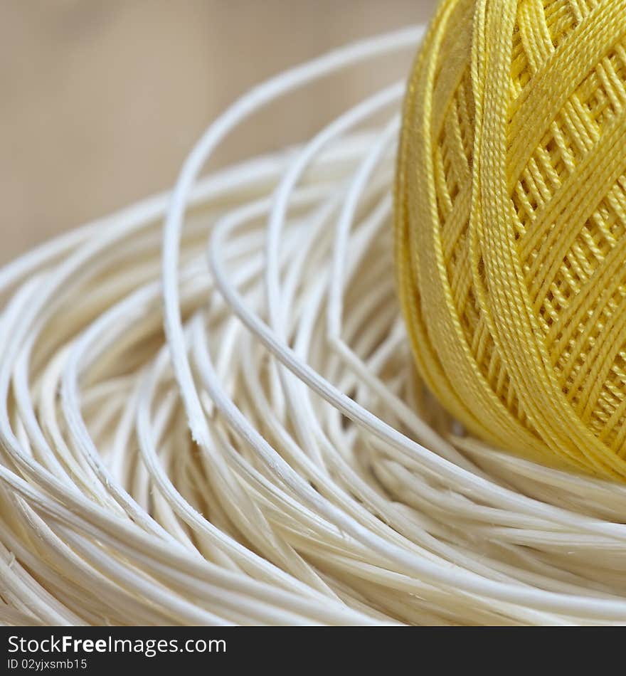 Yellow ball of yarn and decoration wooden element. Yellow ball of yarn and decoration wooden element