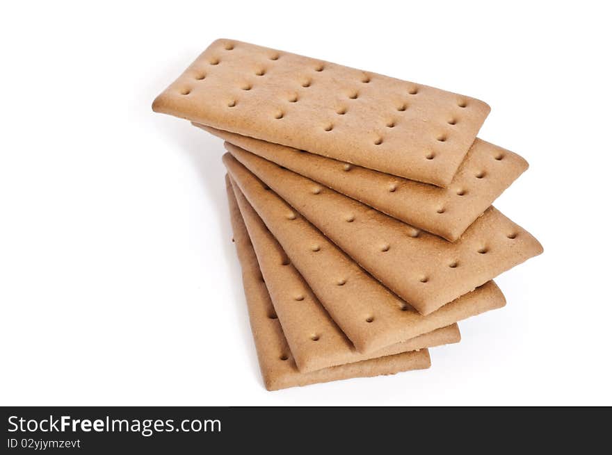 Stack of dark biscuits isolated over white. Stack of dark biscuits isolated over white