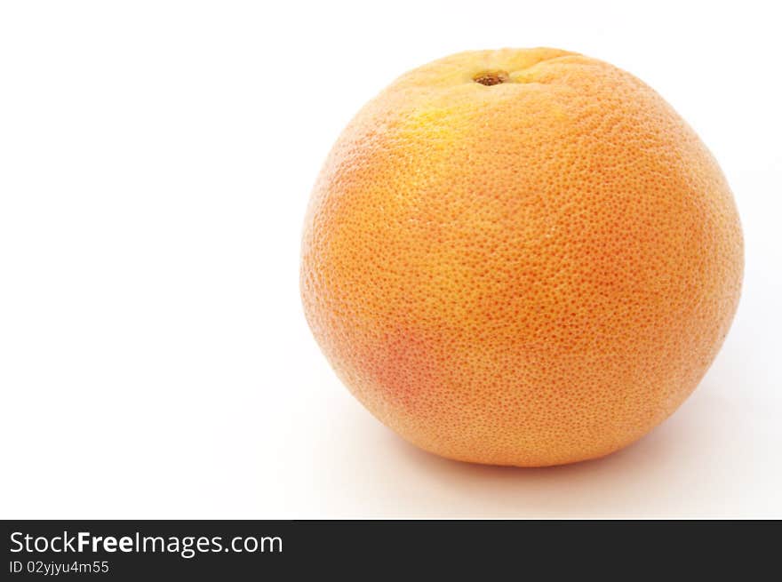 Red round whole ripe grapefruit isolated over white. Red round whole ripe grapefruit isolated over white