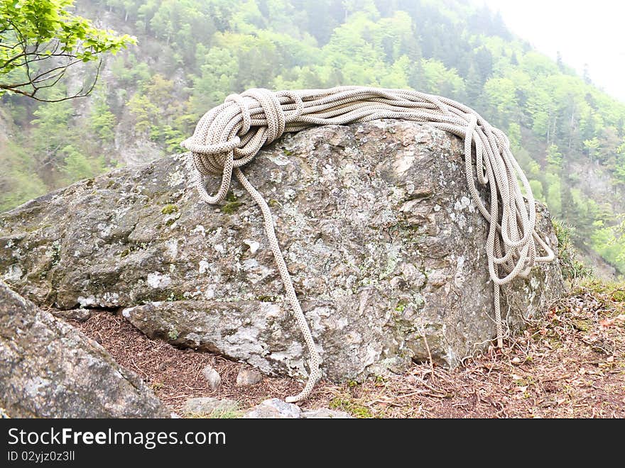 Climbing rope on rock in black forest