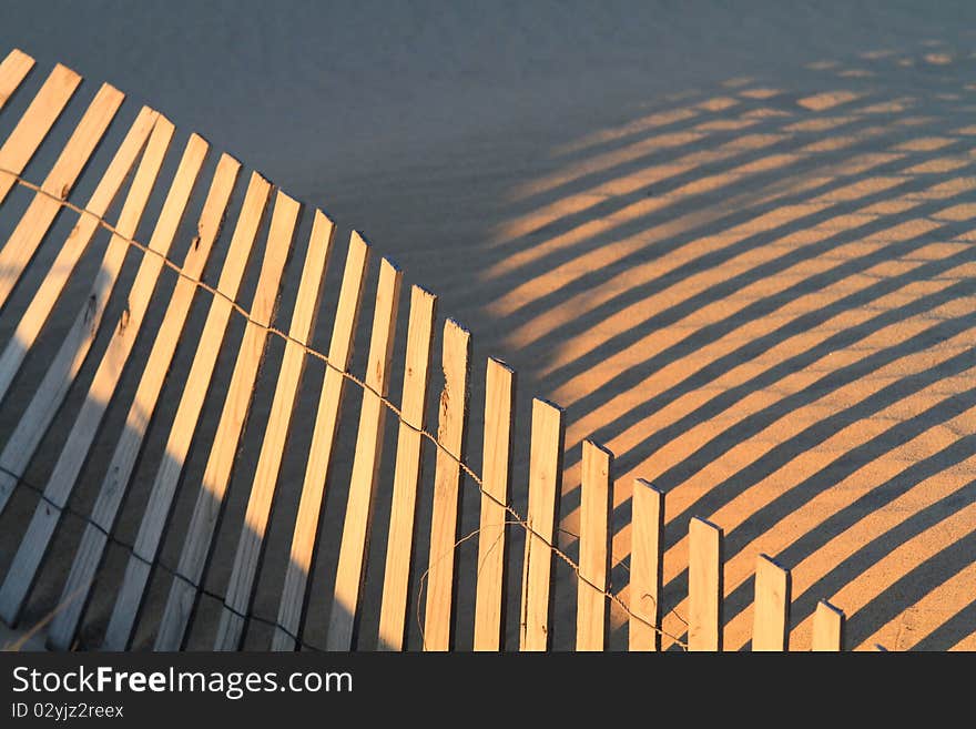 Fence and shadows on french atlantic dune. Fence and shadows on french atlantic dune