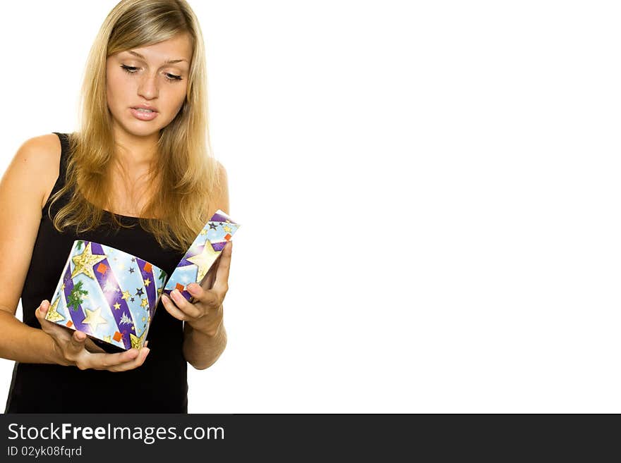 Beautiful young girl opens a gift box. Expressive of surprise. Isolated on white. Beautiful young girl opens a gift box. Expressive of surprise. Isolated on white