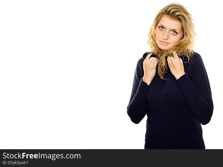 Casual young woman in a blue sweater warms. Isolated on white background