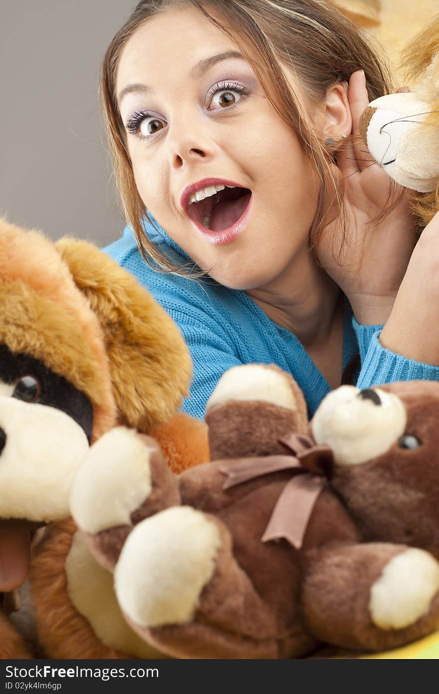 Young woman having fun playing with dolls