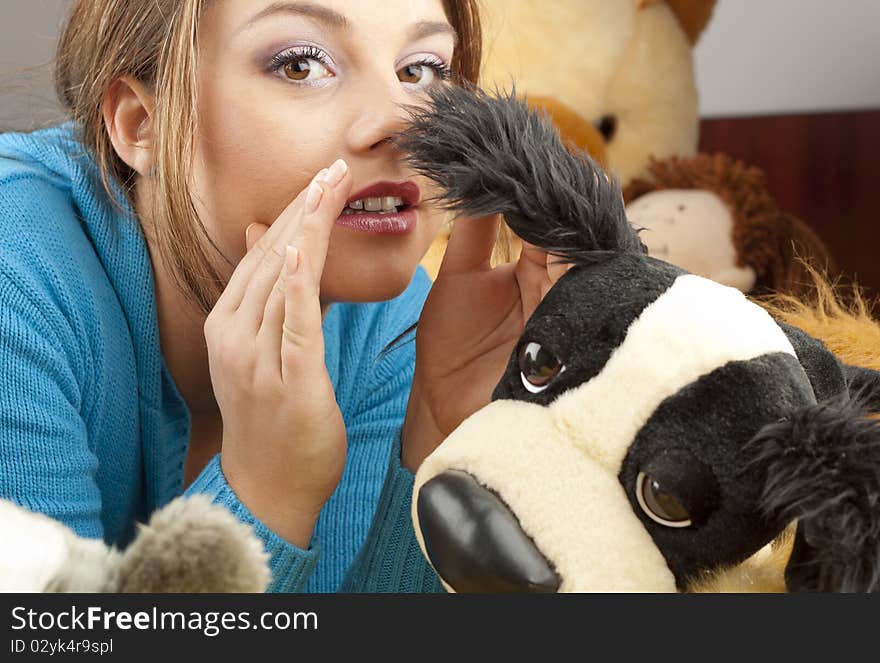 Young woman having fun playing with dolls