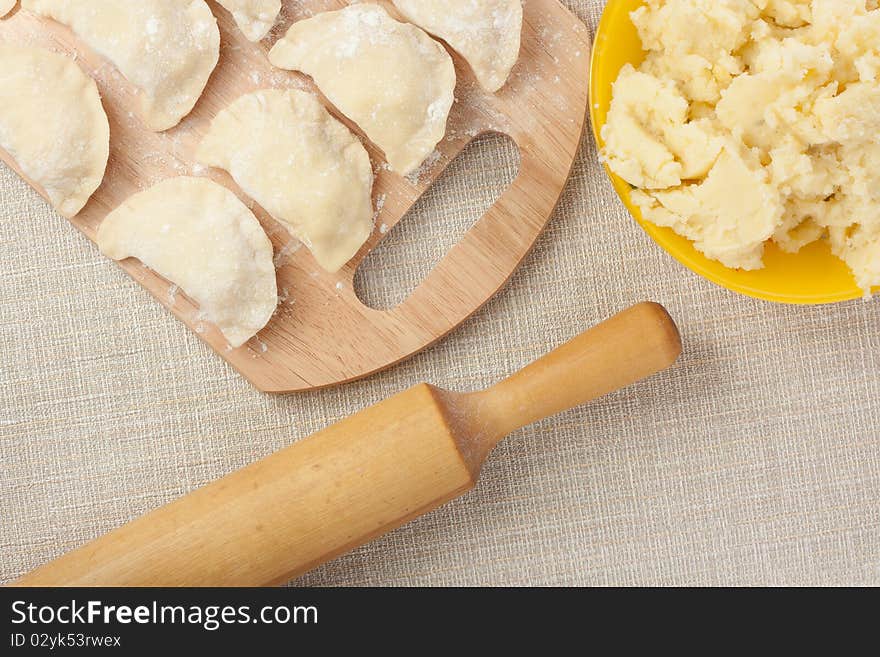 Raw dumplings with rolling pin