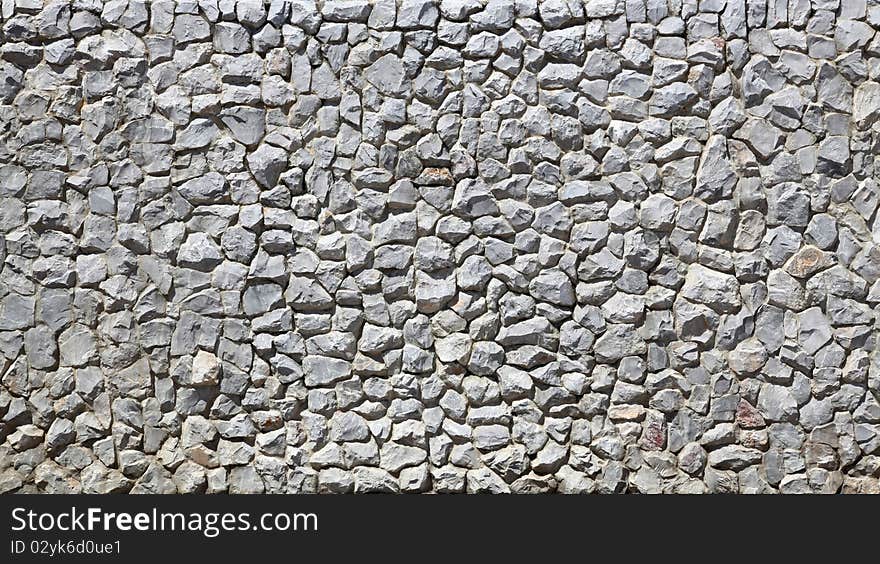 Modern white Brick Wall made of fragment stones in irregular shapes