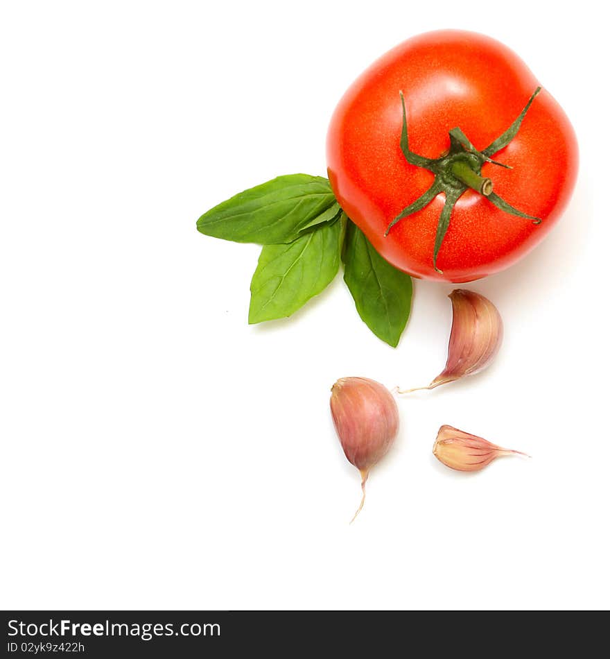 Fresh tomatoes, basil and garlic isolated on white background