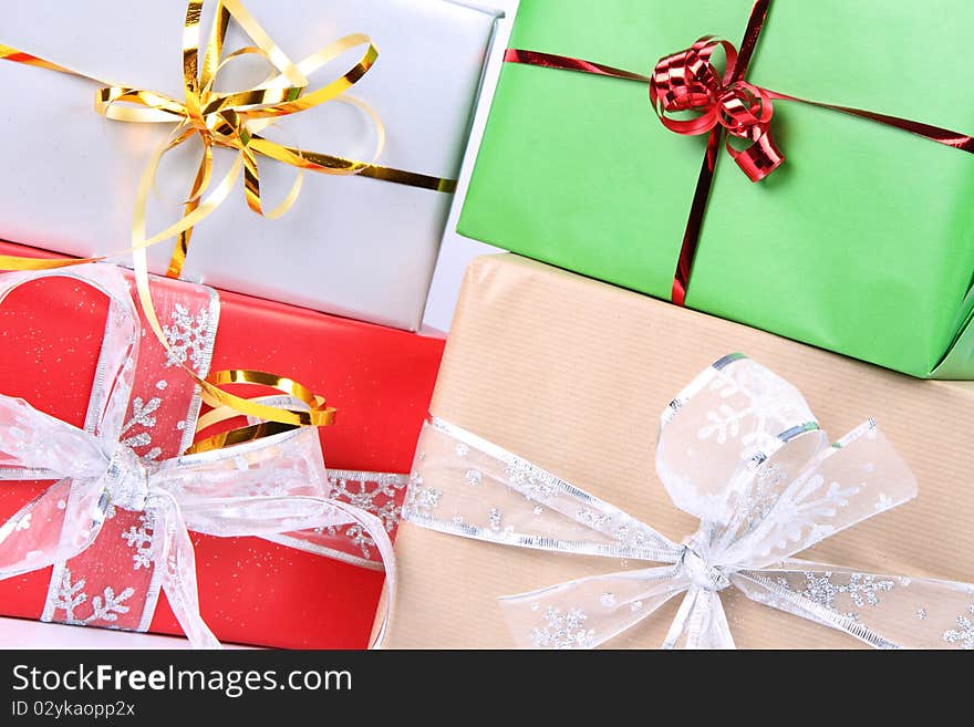 Gifts in silver, green, brown and red wrapping with bows