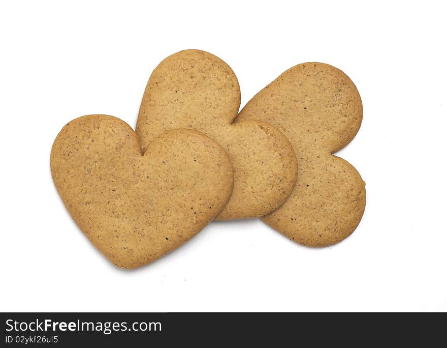 Three heart shaped cookies on white background. Christmas feeling. Three heart shaped cookies on white background. Christmas feeling.