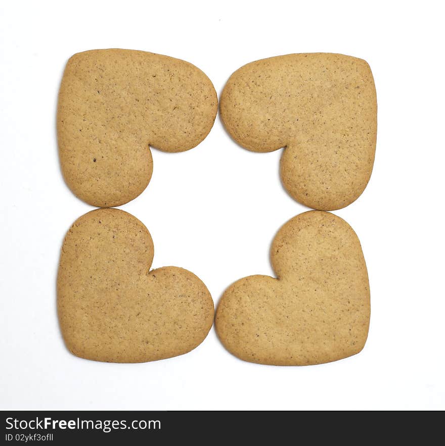 Four heart shaped cookies on white background. Christmas feeling. Four heart shaped cookies on white background. Christmas feeling.