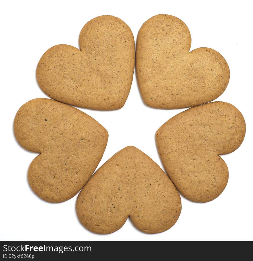 Five heart shaped cookies on white background. Negative space forms a star. Christmas feeling. Five heart shaped cookies on white background. Negative space forms a star. Christmas feeling.