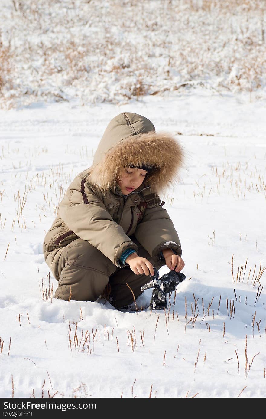 Cute little boy standing in the snow