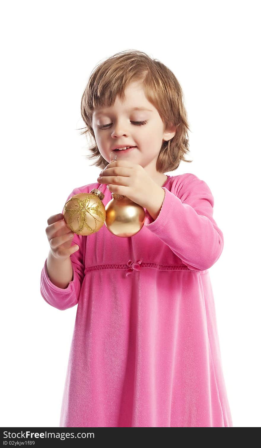 Little girl holding golden christmas balls