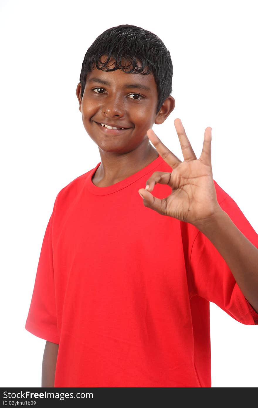 Teenager boy expressing OK signal using hand sign while smile posing in studio against white background. Teenager boy expressing OK signal using hand sign while smile posing in studio against white background