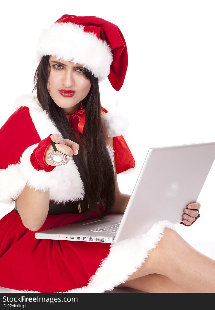 A dark haired Mrs Santa pointing with a laptop. A dark haired Mrs Santa pointing with a laptop