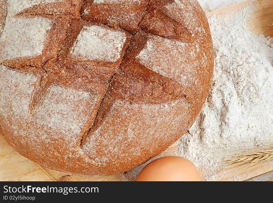 Homemade whole bread and flour on a white background. Homemade whole bread and flour on a white background