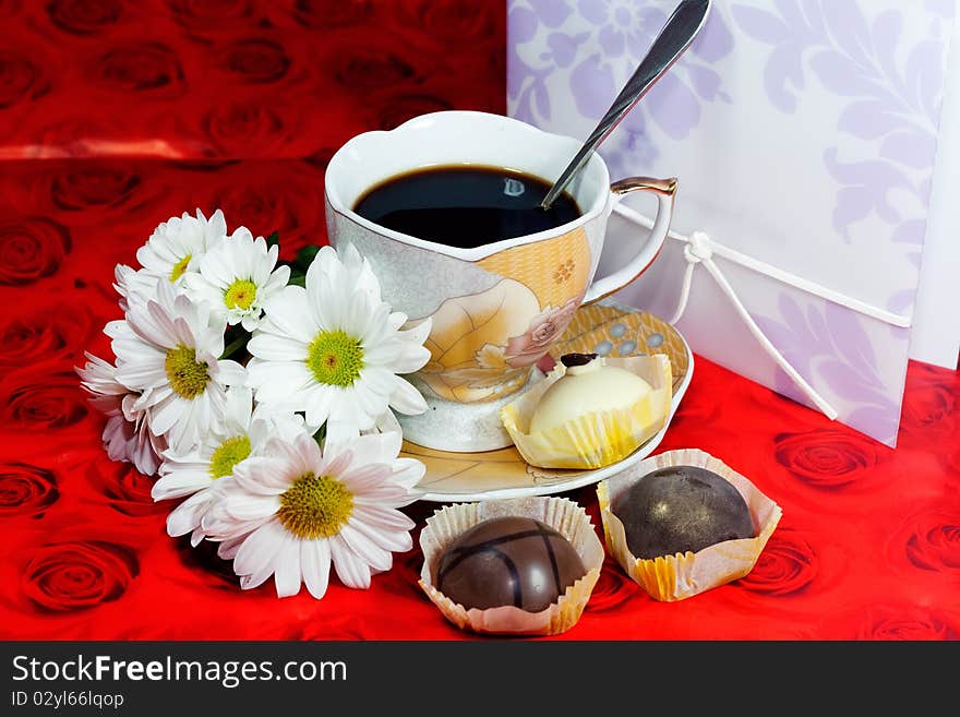 Cup of black coffee, a bouquet of roses and chocolates. Cup of black coffee, a bouquet of roses and chocolates